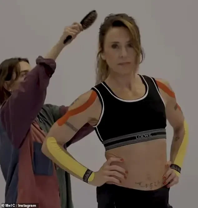 Mel C shows off her Sporty Spice physique as she flashes her toned midriff in a bra top while on stage - 2