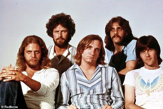 Iconic 70s bassist from legendary band surfaces on rare Malibu outing... can you guess who? - 1