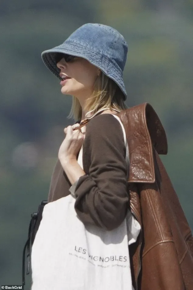 Margot Robbie keeps a low profile in a bucket hat as she enjoys a luxury day out with pal Phoebe Tonkin at celebrity hotspot Club 55 in Saint-Tropez - 3