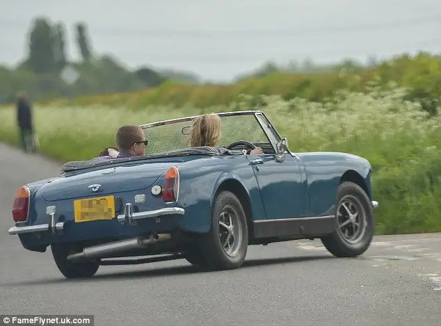 Kate Moss indulges her love of vintage cars as she is spotted zipping around London in classic British convertible - 1