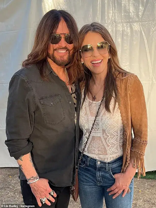 Elizabeth Hurley and Billy Ray Cyrus share a passionate kiss as actress supports singer at country music festival Stagecoach - 1