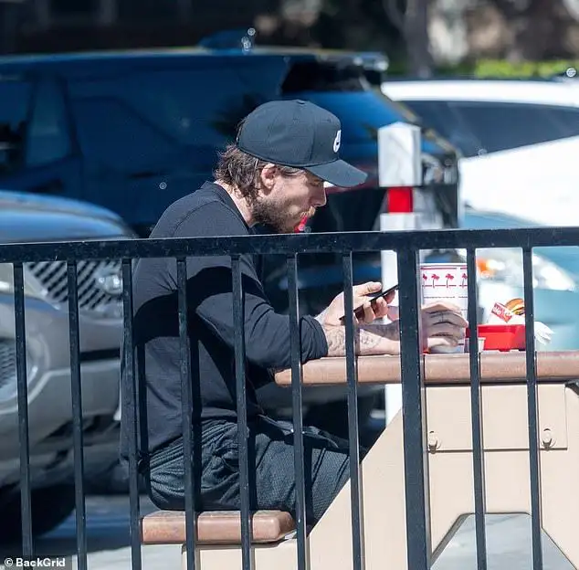 Table for one: Brooklyn Beckham cuts a solitary figure as he dines alone at a fast food restaurant as his family put on a united front at lavish events in New York - 2