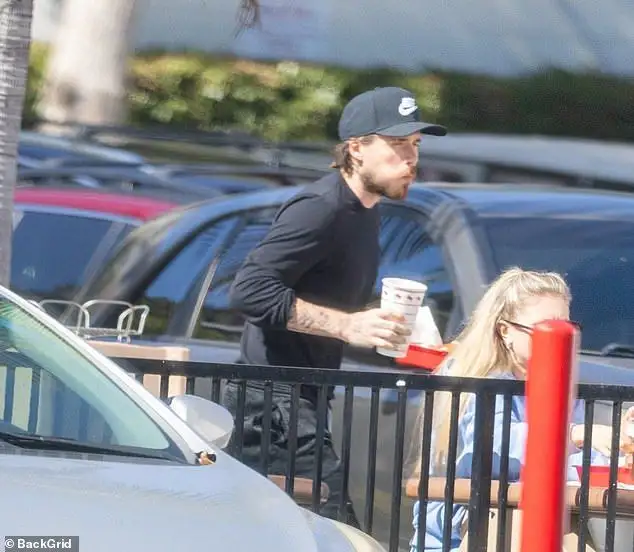 Table for one: Brooklyn Beckham cuts a solitary figure as he dines alone at a fast food restaurant as his family put on a united front at lavish events in New York - 3