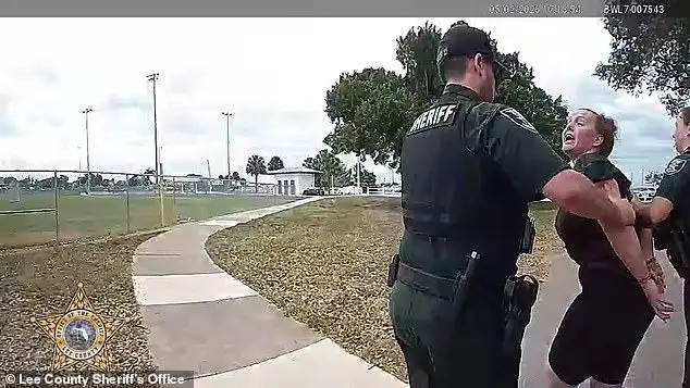 Florida mom's foul-mouthed arrest caught on camera as she is detained for 'storming the field and kicking a child' during youth football game - 2