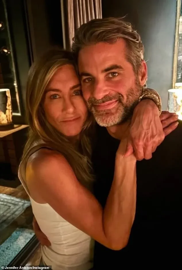 Jennifer Aniston flexes toned arms in navy halter dress during LolaVie event with Charlotte Tilbury - 3