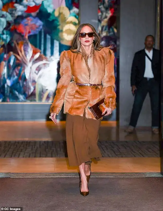 Jennifer Lopez mocked for diva antics as she waits for fans to clear out of the way for a 'staged' paparazzi walk - 1