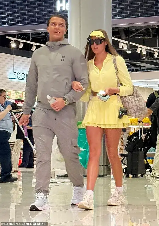 And the bride wore... yellow! Venezuela Fury, 16, changes into a crop top and mini-skirt as she arrives at the airport for her honeymoon with new husband Noah Price, 19 - 1