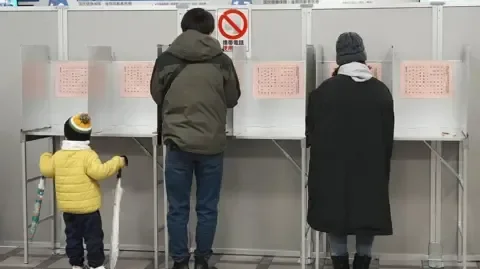 Japan's governing party projected to win snap election majority - 2