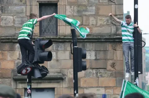 Jubilant Celtic fans celebrate after their club dashes Hearts' title dream - 1