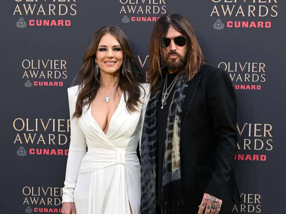Elizabeth Hurley looks sensational in a plunging gown as she joins boyfriend Billy Ray Cyrus and son Damian at the star-studded Olivier Awards - 2